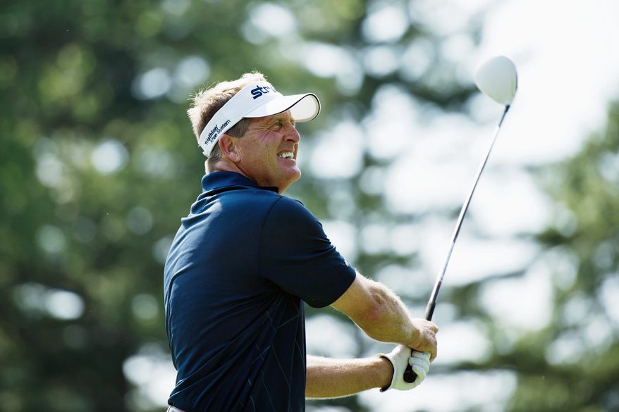 DREW ANGERER/THE WASHINGTON TIMES
PGA Tour veteran Fred Funk puts body english on his tee shot on the 10th hole on the North Course during a 36-hole U.S. Open qualifier at Woodmont Country Club in Rockville. Funk made the cut with a 6-under 135.