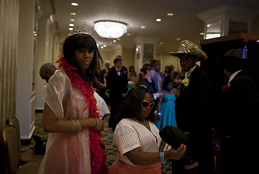 Students at the Cinderella Ball try on comical sunglasses and hats before entering a photo booth at The Willard Intercontinental Hotel in Washington, D.C. on Sunday, June 5, 2011. This was the sixth annual Cinderella Ball, where students with life-threatening illnesses or disabilities came together to celebrate. (Pratik Shah/The Washington Times)