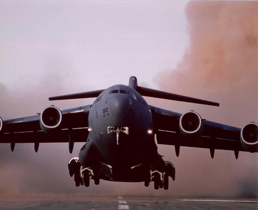 ** FILE ** A U.S. Air Force C-17 transport plane lifts off in March 1995. (AP Photo/McDonnell Douglas, File)