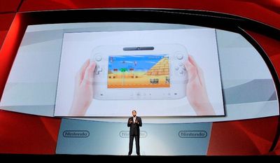 ASSOCIATED PRESS
Reggie Fils-Aime, president of Nintendo of America, introduces the Wii U gaming console at the E3 Gaming Convention in Los Angeles on Tuesday. Its controller contains a 6.2-inch touch screen so gamers can play while others watch TV.