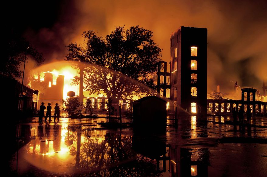 ASSOCIATED PRESS
Flames engulf the former Alice Mills Rubber Manufacturing Plant in Woonsocket, R.I., on Tuesday night. The eight-alarm fire at the historic mill, built in 1889, forced evacuations and left hundreds without power, officials said. The blaze means a rethinking of development plans for the site, now owned by American Wood Pellet Co., which the city hopes will bring much-needed jobs to the city of 43,000.
