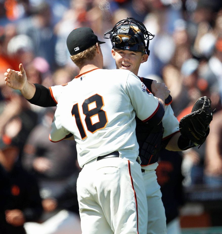 Giants catcher Eli Whiteside celebrates with starting pitcher Matt Cain after Wednesday's victory against the Nationals in San Francisco. (Associated Press)