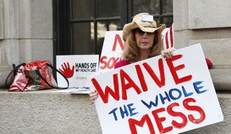 Betsy Burgess of Flowery Branch, Ga., protests President Obama&#x27;s health care reform plan outside the 11th U.S. Circuit Court of Appeals in Atlanta on June 8, 2011. (Associated Press)