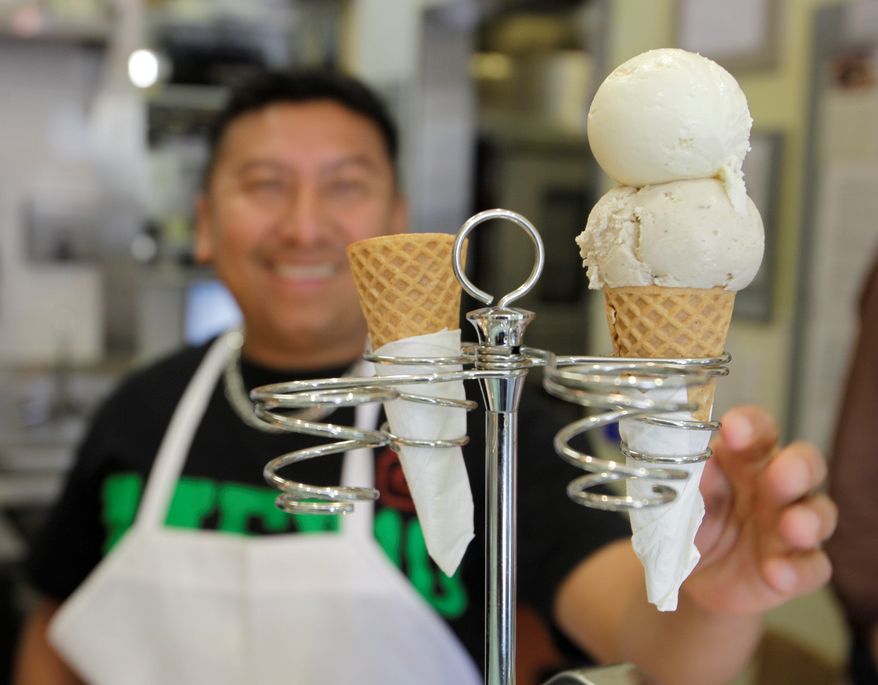 Scooper Daniel Tzek puts an ice cream cone in a holder for a customer at the Bi-Rite Creamery in San Francisco.The creamery's soft-serve flavors include vanilla, of course, but also spicy Mexican chocolate, and balsamic strawberry. It also has salted caramel, which marketing director Kirsten Bourne said is "the most popular flavor by far." (Associated Press)