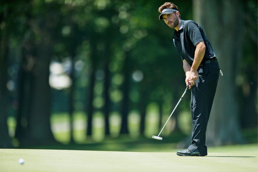 Ty Tryon strikes a putt during the U.S. Open qualifying tournament at Woodmont Country Club in Rockville on Monday. Tryon shot 6-under 135 for 36 holes and made the cut. (Drew Angerer/The Washington Times)