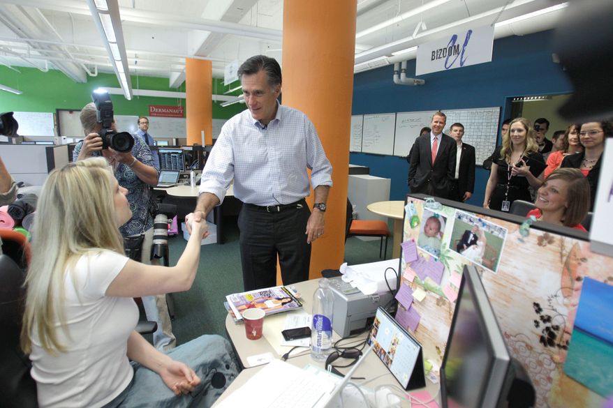 Republican presidential hopeful Mitt Romney meets with Krysalis Fit CEO Jennine Hynes at Bizdom University in Detroit on Thursday. Bizdom is a business development center to help people in Michigan. It provides real-world training, mentorship and support for entrepreneurs. (Associated Press)