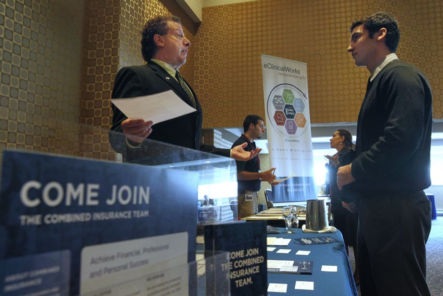 Mitchell Orenstein (left), market director for Combined Insurance, speaks with Gabriel Moraga of Somerville, Mass., at a job fair in Boston on Tuesday, June 7, 2011. (AP Photo/Steven Senne)