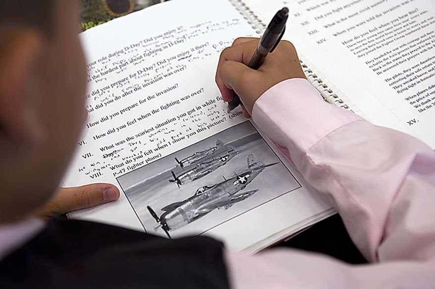 A student takes notes during one of the small-group interviews with World War II vets at Rocky Run Middle School in Chantilly, Va.'s annual World War II Day, called "The Latest Generation Meets the Greatest Generation," on Thursday, June 9, 2011. (Barbara L. Salisbury/The Washington Times)