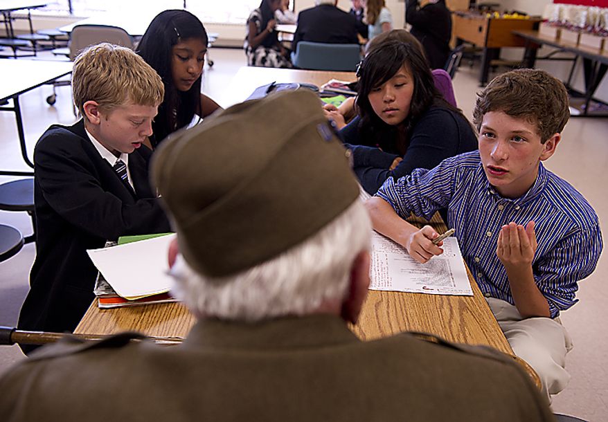 Joey Cronin, 13, right, asks WWII vet William Hanusek how the war changed him as his fellow Rocky Run Middle School students (from left) Kincaid Youman, 13, Mahatha Kambham, 12, and Crystal Pan, 13, listen in. Hanusek was one of more than 100 WWII vets who came to the Chantilly, Va., school on Thursday, June 9, 2011 to participate in the school's  annual World War II Day, called "The Latest Generation Meets the Greatest Generation." The day included small-group interviews with WWII vets as well as panel discussions and World War II-inspired entertainment provided by the students.  (Barbara L. Salisbury/The Washington Times)
