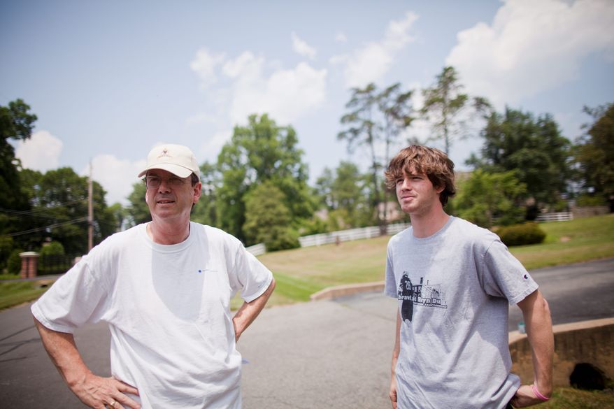 Hill Slowinski, of Potomac, and son Brooke, live across the street from the fifth hole at Congressional Country Club. During the U.S. Open, Mr. Slowinski offers his yard as a parking lot for spectators. (Pratik Shah/The Washington Times)
