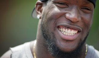 Brian Orakpo talks with reporters after joining other members of the Washington Redskins for an informal practice at a facility in northern Virginia, Tuesday, June 14, 2011. (Rod Lamkey Jr./The Washington Times)