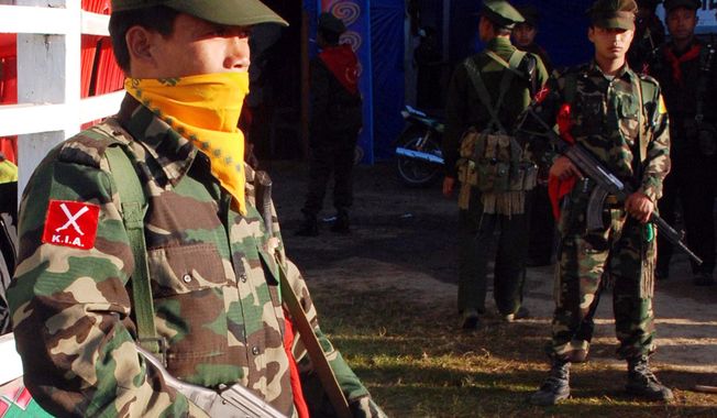 The military wing of the Kachin Independence Army provides security for the Kachin New Year celebration in January 2010. Myanmar troops have attacked Kachin forces to try to drive them from an area by China&#x27;s border. (Associated Press)