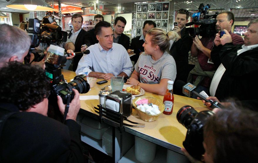 ASSOCIATED PRESS
Former Massachusetts Gov. Mitt Romney, a Republican presidential hopeful, talks with a woman eating breakfast at the counter of a diner as they are surrounded by photographers and reporters during a campaign stop in Derry, N.H., on Tuesday. Many of the GOP candidates took advantage of campaigning in the state after Monday evening&#39;s Republican presidential debate.