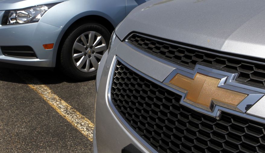 A detail of the grill of a 2011 Chevrolet Cruze compact car (right) is seen near another Cruze on the lot of a dealership in Norwood, Mass., on Tuesday, May 31, 2011. Americans bought fewer cars in May, pulling retail sales down for the first time in nearly a year. (AP Photo/Steven Senne)
