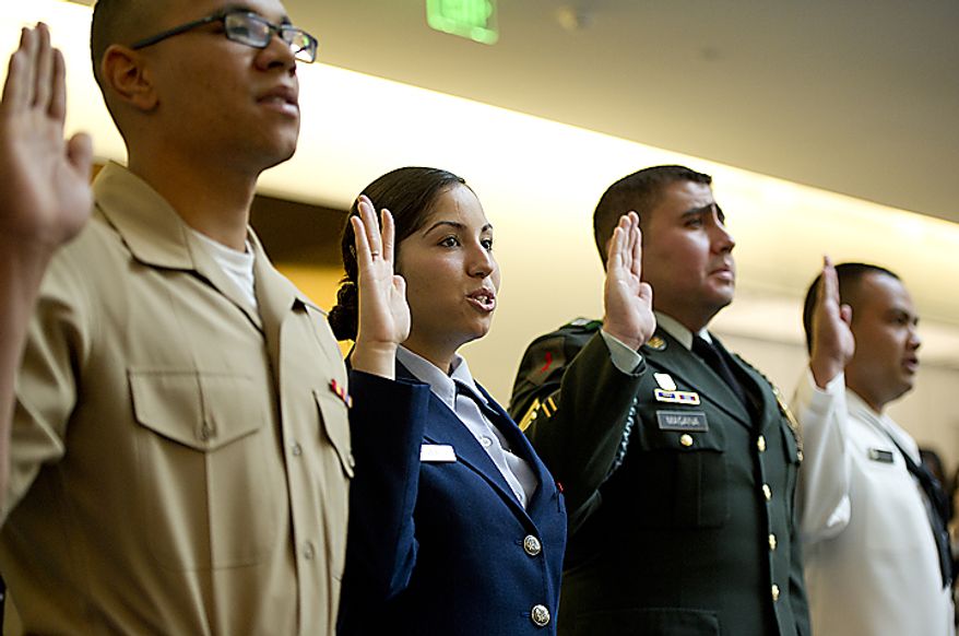 From left, U.S. Marine Cpl. Dominic Vincentz, , originally from Germany; Sr. Airman Deborah Vives, USAF, originally from Mexico; U.S. Army Sgt. Kelvin Magana, originally from El Salvador; and U.S. Navy sailor Halin Edwin, originally from Micronesia, take their oath of citizenship on Flag Day, Tuesday, June 14, 2011 at the National Museum of American History in Washington, D.C. Twenty people from 12 different countries, including these four who have been serving in the U.S. Armed Forces, became naturalized citizens. (Barbara L. Salisbury/The Washington Times)