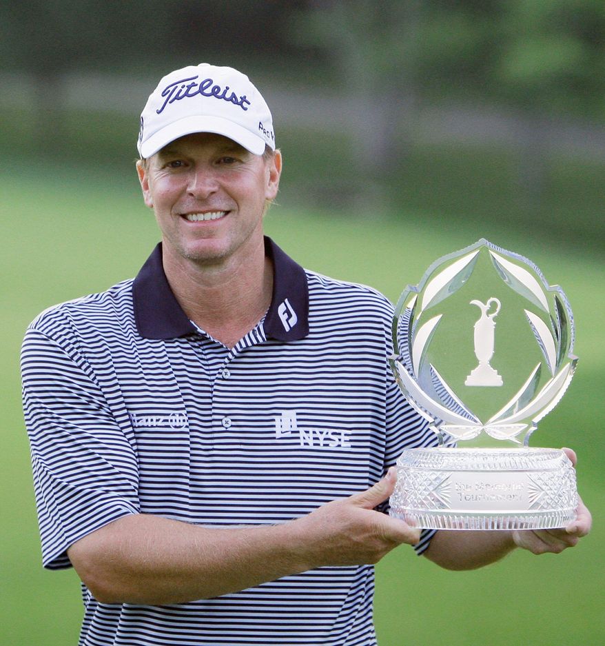 Steve Sticker holds up the trophy after winning the Memorial golf tournament at the Muirfield Village Golf Club in Dublin, Ohio, Sunday, June 5, 2011. Stricker finished at 16-under par for the tournament. (AP Photo/Tony Dejak)