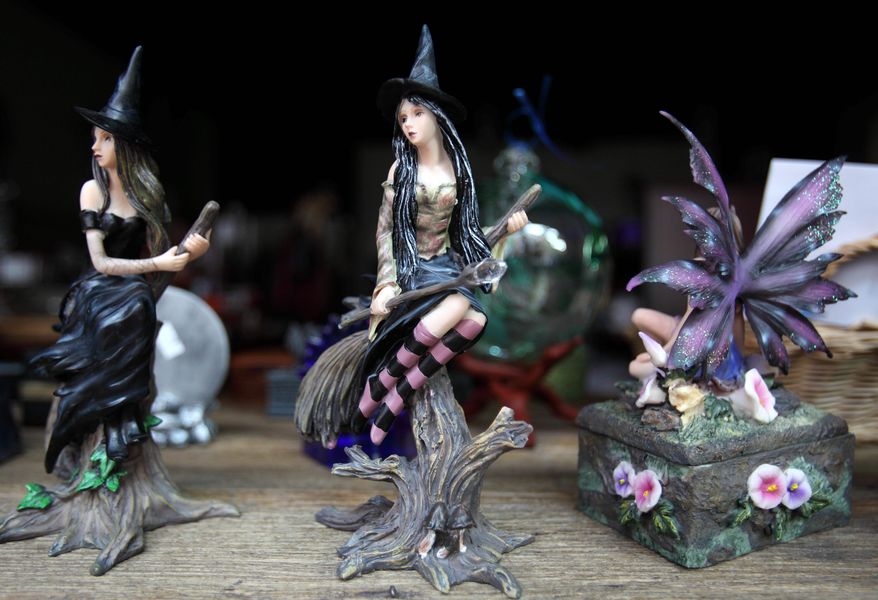 This Friday, June 10, 2011 photo shows These are typical touri witch figurines displayed in a shop window in Salem, Mass. Salem, home to the infamous witch trials of the 17th century, sees its ties to witchcraft as a blessing and a curse. The historic Massachusetts seaport is trying _ yet again _ to rebrand itself for visitors as something other than a place linked to witches. (AP Photo/Michael Dwyer)