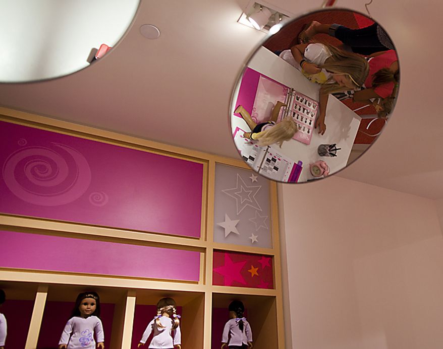 Sophie McMullen, 7, from Leesburg, Va. chooses the hair style she wants her doll, "Kit" to have in the Doll Hair Salon at American Girl during the store's soft opening at Tyson's Corner Center in McLean, Va. on Thursday, June 16, 2011. The grand opening of American Girl is Saturday, June 18. (Pratik Shah/The Washington Times)