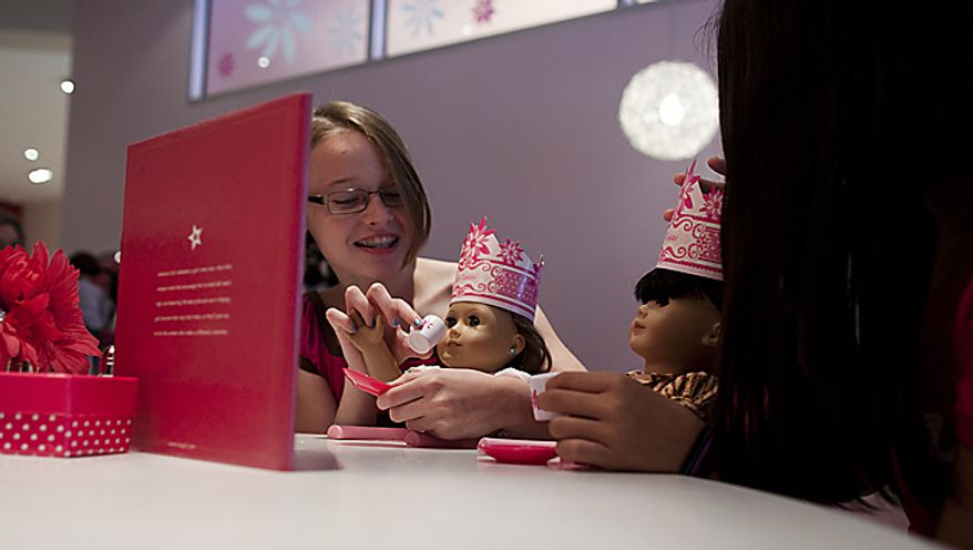 Laura Richards, 11, and Michelle Finta, 12, from Burtonsville, Md. sit with their dolls at the American Girl Bistro during the store's soft opening at Tyson's Corner Center in McLean, Va. on Thursday, June 16, 2011. The grand opening of American Girl is Saturday, June 18. (Pratik Shah/The Washington Times)