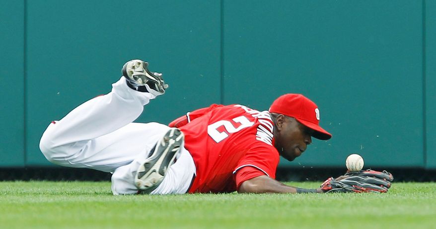 ASSOCIATED PRESS
Nationals center fielder Roger Bernadina can't come up with a second-inning single by the Orioles' Derrek Lee, who below right collides with Nats second baseman Danny Espinosa. Lee went 9 for 13 in the three-game series, raising his average from .214 to .245.