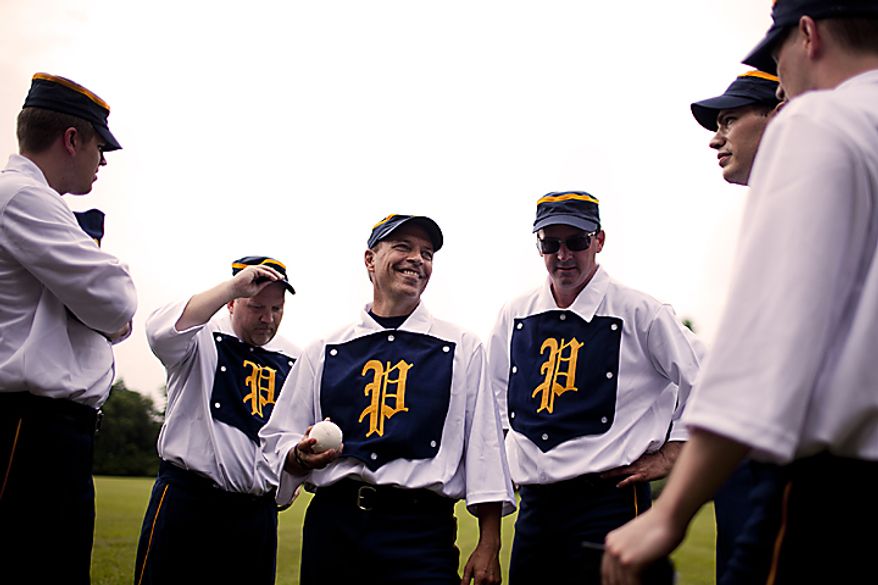 Potomac Nine pitcher J.D. "Buckeye" Almond, of Marshall, Va., in the center, smiles at his teammates during the Loudoun Preservation Society's 19th Century Baseball Day at the Oatlands, in Leesburg, Va., Sunday, June 12, 2011. "The camaraderie is just great," he said. "We all love the game and it's blast out here." (Drew Angerer/The Washington Times)