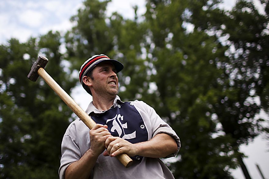 Elkton Eclipse catcher Tim "Ones" Bower, of Rising Sun, Md., warms up on deck with a "hammer" weighted bat during the Loudoun Preservation Society's 19th Century Baseball Day at the Oatlands, in Leesburg, Va., Sunday, June 12, 2011. "It doesn't really help me warm up and it's probably messing up my swing, but it's what they used to use." (Drew Angerer/The Washington Times)