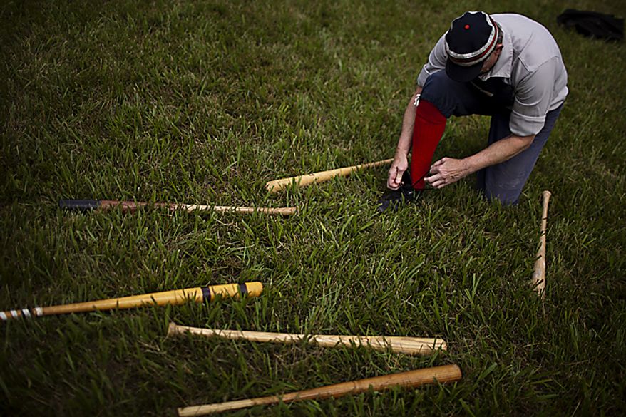 67 year-old Elkton Eclipse player Bill "Pockets" Freeland, from Cecil County, Md., ties his shoe between innings during their game against the Potomac Nine team during the Loudoun Preservation Society's 19th Century Baseball Day at the Oatlands, in Leesburg, Va., Sunday, June 12, 2011. This is Freeland's third year playing in the league and he said he enjoys it more than softball leagues. "I'll keep playing this until I forget which way to run, then I may take up golf," he joked. Freeland was the oldest player on the field that day. (Drew Angerer/The Washington Times)