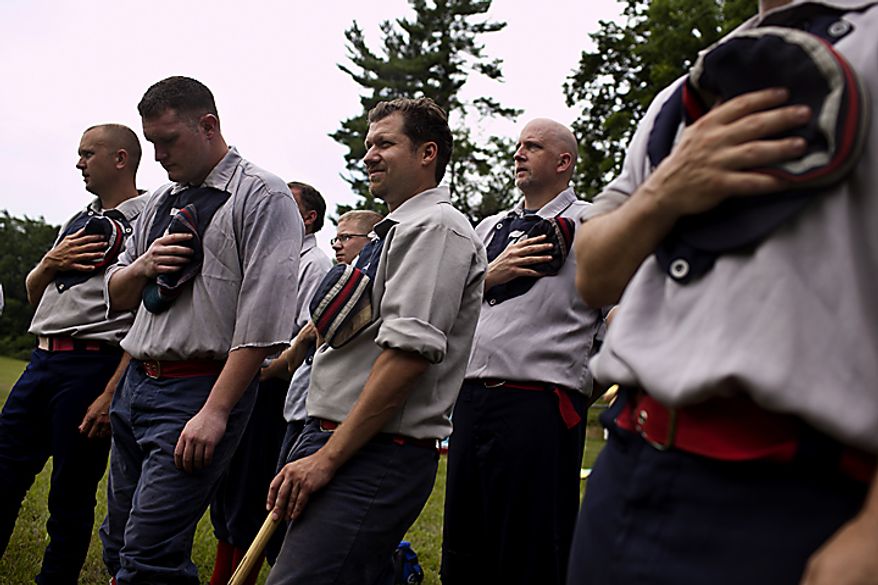 The Elkton Eclipse team, based out of Elkton, Md, hold their hats over their hearts during the National Anthem before the game against the Potomac Nine during the Loudoun Preservation Society's 19th Century Baseball Day at the Oatlands, in Leesburg, Va., Sunday, June 12, 2011. Unlike today's game, the umpire instructed fans and players to all sing in unison, instead of just one person singing at the start. (Drew Angerer/The Washington Times)