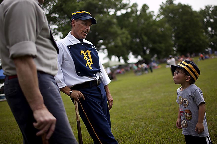 Potomac Nine pitcher J.D. "Buckeye" Almond, of Marshall, Va., talks to his son Wyatt, at right, before the games started at the Loudoun Preservation Society's 19th Century Baseball Day at the Oatlands, in Leesburg, Va., Sunday, June 12, 2011. Almond had many friends and family on hand to watch, as historically the day was a social affair. (Drew Angerer/The Washington Times)