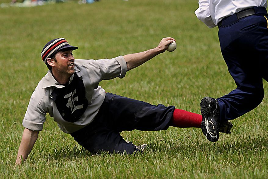 Tim "Ones" Bower tries to tag out a runner during the Loudoun Preservation Society's 19th Century Baseball Day at the Oatlands, in Leesburg, Va., Sunday, June 12, 2011. (Drew Angerer/The Washington Times)