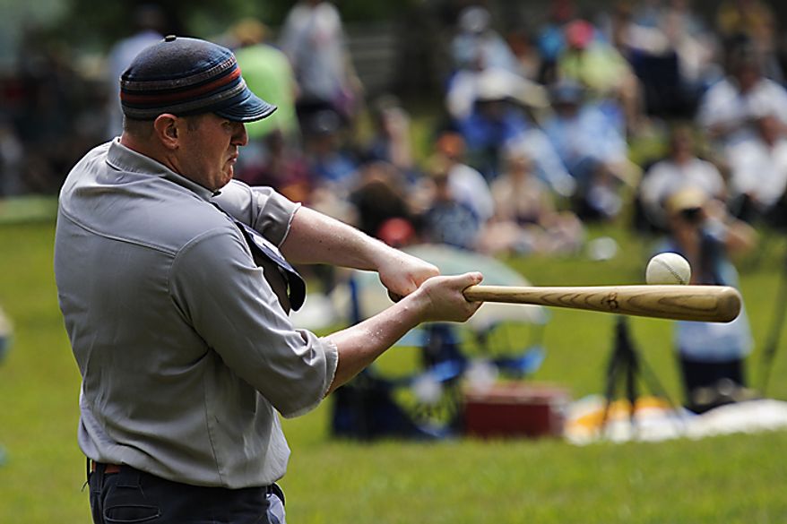 Elkton Eclipse outfielder Glyn "Hammer" Richards, left, of Mt. Ephraim, N.J., hits a pitch during a game during the Loudoun Preservation Society's 19th Century Baseball Day at the Oatlands, in Leesburg, Va., Sunday, June 12, 2011. The bats they used during the 1860s era are a little different from today's bats. Still made of wood, the vintage era bats had a thicker handle but a more narrow barrel. (Drew Angerer/The Washington Times)