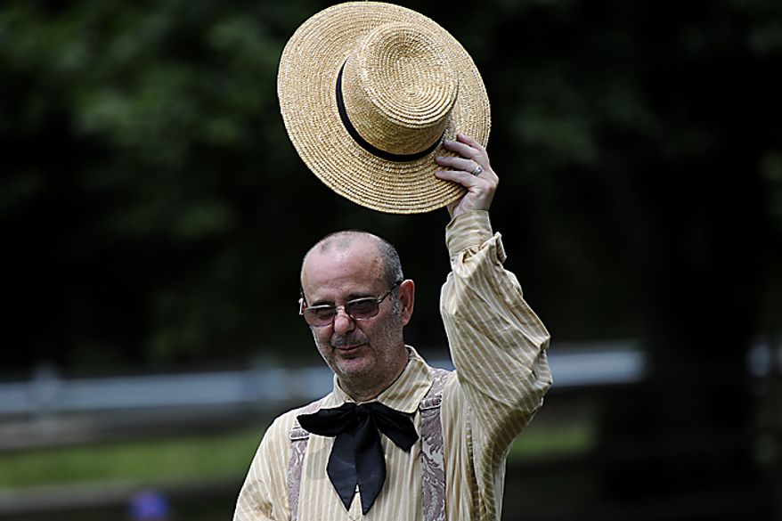 Umpire Richard D'Ambrisi tips his hat to the crowd as the game starts between the Potomac Nine and the Elkton Eclipse during the Loudoun Preservation Society's 19th Century Baseball Day at the Oatlands, in Leesburg, Va., Sunday, June 12, 2011. D'Ambrisi also serves as the league official historian of 1860s era baseball. (Drew Angerer/The Washington Times)