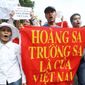 Vietnamese protesters carry a banner with a slogan saying, &quot;Paracel Islands and Spratly Islands belong to Vietnam,&quot; in Hanoi earlier this month. Protesters tell China to stay out of their waters after Beijing&#39;s increased activities around disputed areas. (Associated Press)