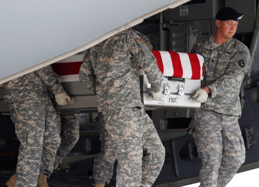 An Army carry team carries the transfer case containing the remains of Army Pfc. Brian J. Backus of Saginaw Township, Mich., upon arrival at Dover Air Force Base, Del. on Tuesday, June 21, 2011. The Department of Defense announced the death of Backus who was supporting Operation Enduring Freedom in Afghanistan.(AP Photo/Jose Luis Magana)