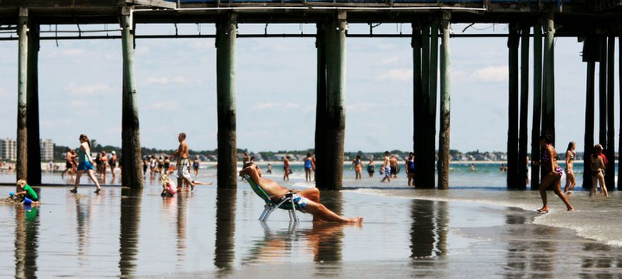 People enjoy the first day of summer at Old Orchard Beach, Maine on Tuesday, June 21, 2011. (AP Photo/Pat Wellenbach)