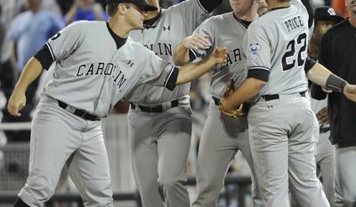 South Carolina players, including Matt Price (22) celebrate their 7-1 win over Virginia in an NCAA College World Series baseball game in Omaha, Neb., Tuesday, June 21, 2011. (AP Photo/Eric Francis)
