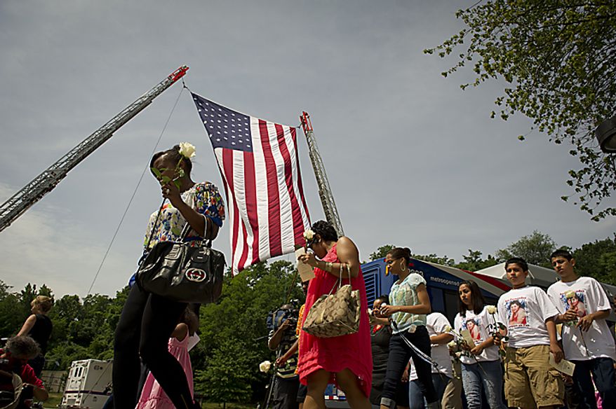 Family members and friends of the nine people killed in a June 22, 2009, Metrorail crash proceed during a memorial service on June 22, 2011, to the Fort Totten Metrorail Station in Washington, D.C., for a wreath laying ceremony. (Rod Lamkey Jr./The Washington Times)