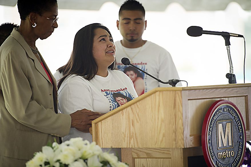 Evelyn Fernandez (center) cries as she talks about the memory of her mother, Ana Fernandez, during a memorial service on June 22, 2011, near the Fort Totten Metro Station in Washington, D.C., for the nine people killed in a Metrorail crash two years ago. Ana Fernandez was one of those killed in the crash. (Rod Lamkey Jr./The Washington Times)
