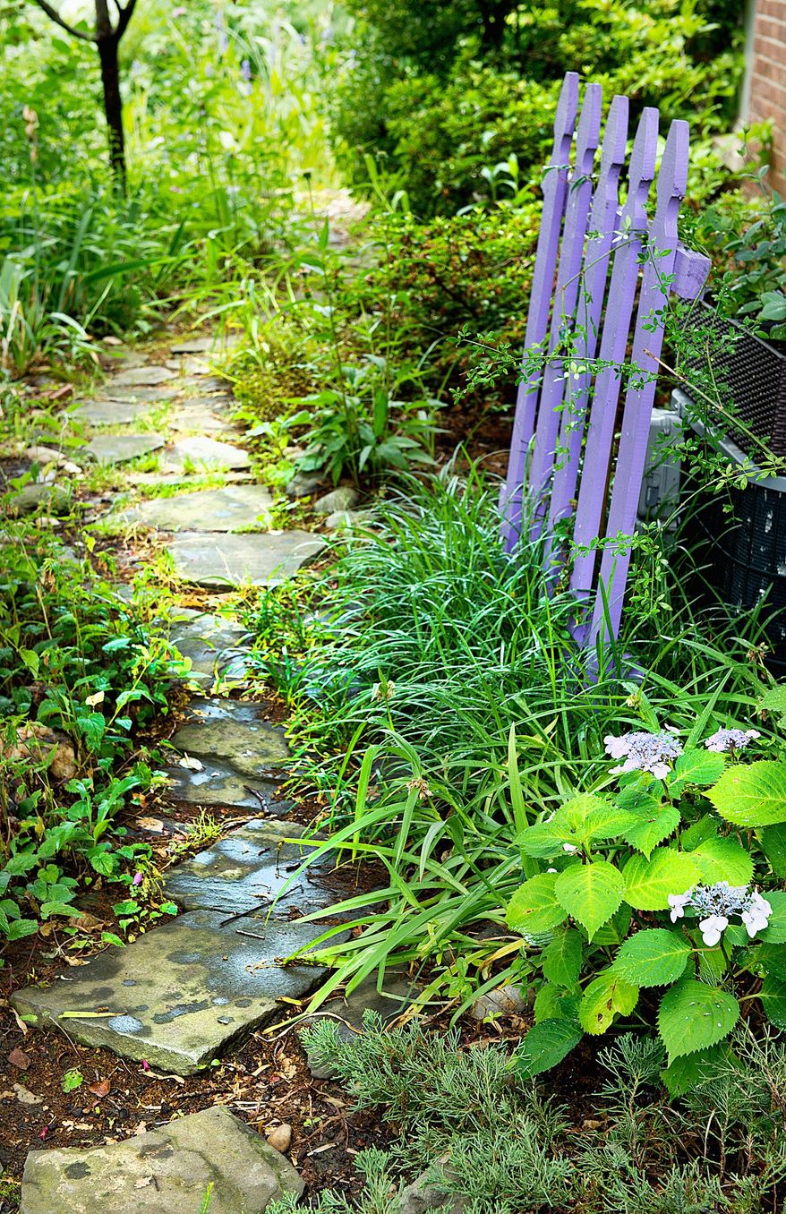 Cottage gardens often feature quaint or comfortable accessories, such as a picket fence or stone pathway.