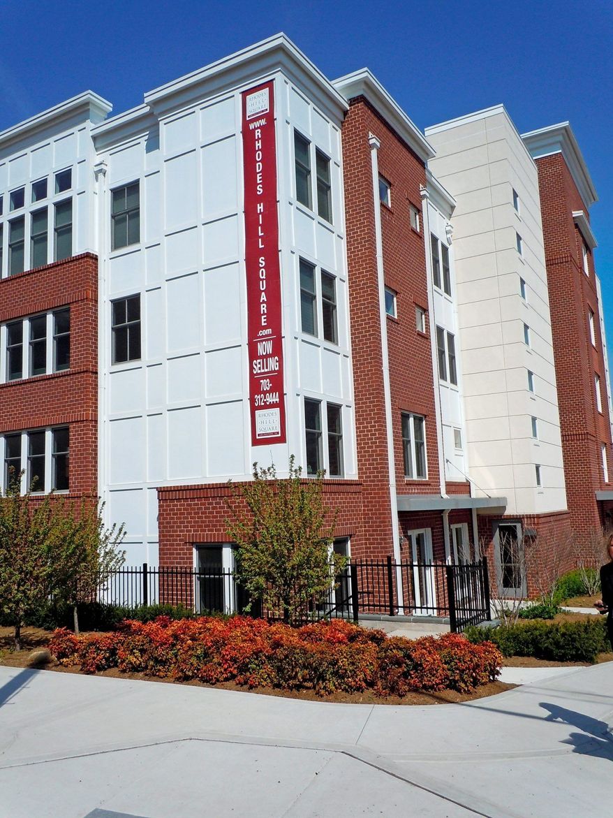 Waterford Development is building 89 condominiums at Rhodes Hill Square in Arlington. The three low-rise buildings have a red brick exterior and white trim.