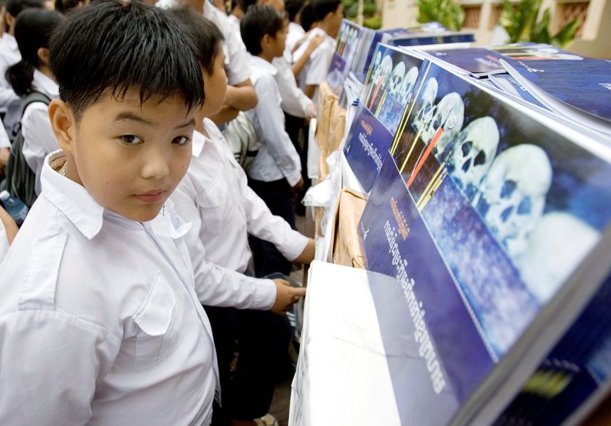 Associated Press photographs
Cambodian students look at books about the Khmer Rouge at a high School in Phnom Penh. Eight years after the creation of a U.N.-backed multinational panel to hold trials on the regime, it is riven by suspicion.