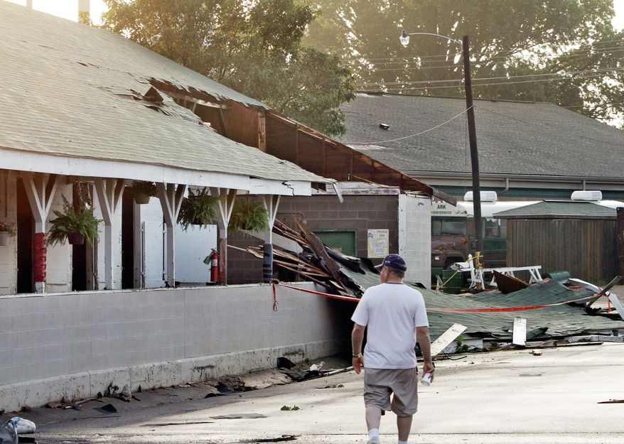 ASSOCIATED PRESS
Trainer Lynn Whiting walks through the stable area Thursday at Churchill Downs in Louisville, Ky., surveying damage to at least nine barns by an apparent tornado Wednesday night. No horses or people were injured in the storm, but Thursday's scheduled races were canceled.