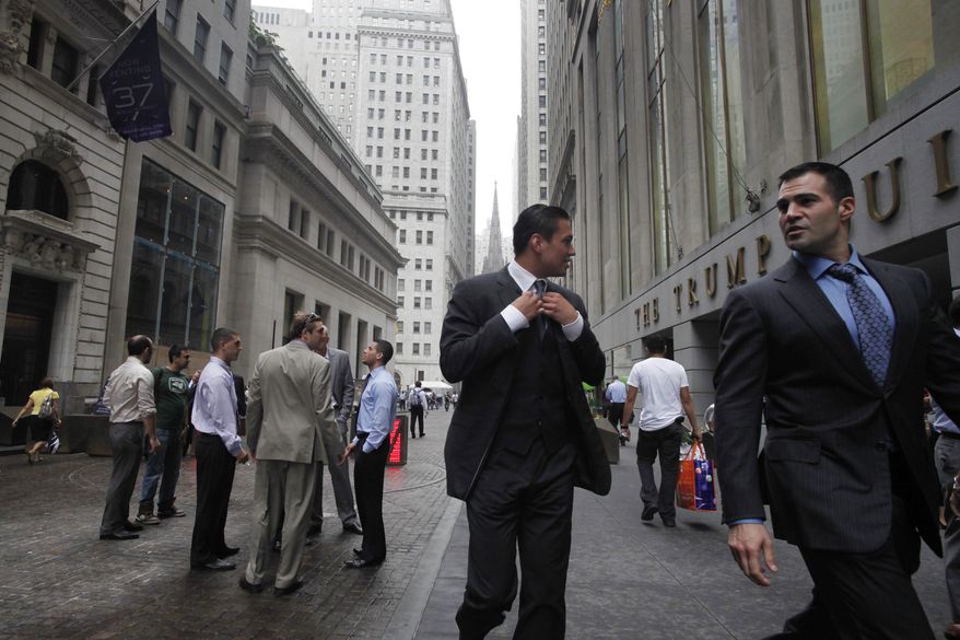 Businessmen walk June 23, 2011, on Wall Street in New York. (Associated Press)