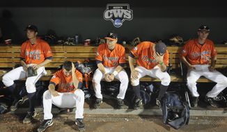 Virginia players sit in the dugout after losing 3-2 to South Carolina in 13 innings in an NCAA College World Series baseball game in Omaha, Neb., Friday, June 24, 2011. South Carolina advances to the championship series. (AP Photo/Dave Weaver)