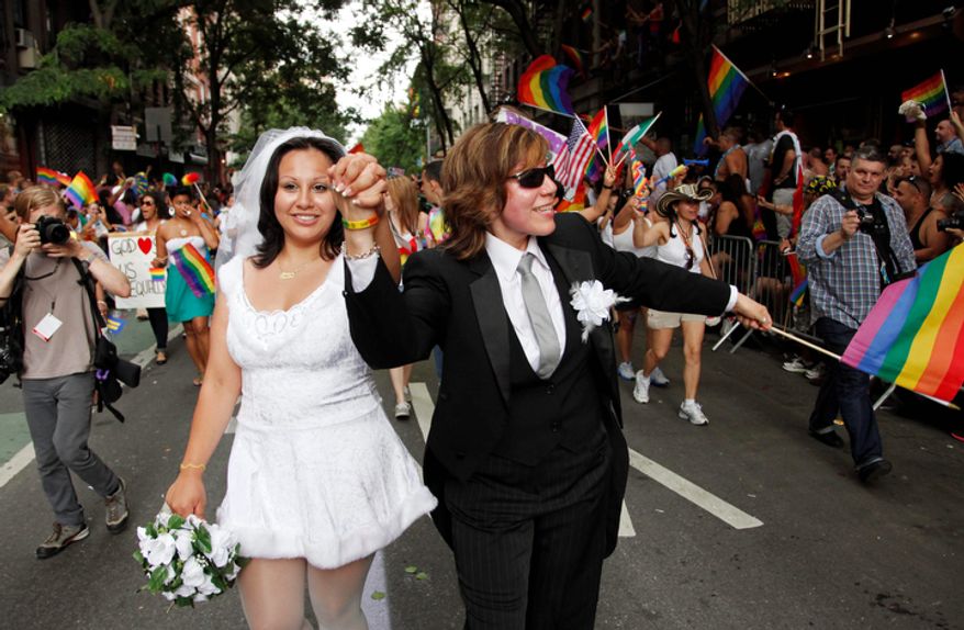 ** FILE ** Paola Perez, left, and her partner Linda Collazo, march in the Gay Pride parade in New York Sunday, June 26, 2011. One of the world's oldest and largest gay pride parades was expected to become a victory celebration after New York's historic decision to legalize same-sex marriage. (AP Photo/Mark Lennihan) (AP Photo/Mark Lennihan)