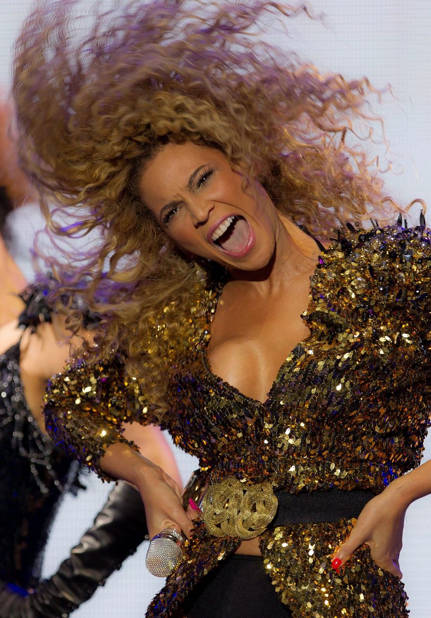 U.S singer Beyonce performs on the Pyramid stage at Glastonbury Music Festival, in Glastonbury, England, Sunday, June 26, 2011. More than 170,000 ticket-holders are at Worthy Farm for the 41st Glastonbury Music Festival. (AP Photo/Joel Ryan)