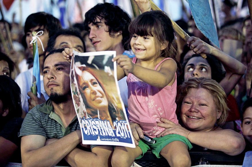 A girl holds a poster of Argentina's President Cristina Fernandez, who is favored to win a second term, during a political rally in Buenos Aires. (Associated Press)