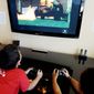 **FILE** Two boys, ages 9 and 13, play “Grand Theft Auto IV” in Los Altos, Calif. (Associated Press)