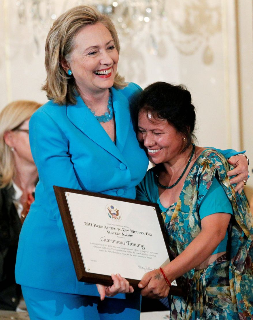 ASSOCIATED PRESS
Secretary of State Hillary Rodham Clinton hugs Charimaya Tamang of Nepal, a trafficking victim, as she receives the 2011 Hero Acting to End Modern-Day Slavery Award on Monday at the State Department. The U.S. says 23 nations could face sanctions for failing to do more to fight human trafficking.