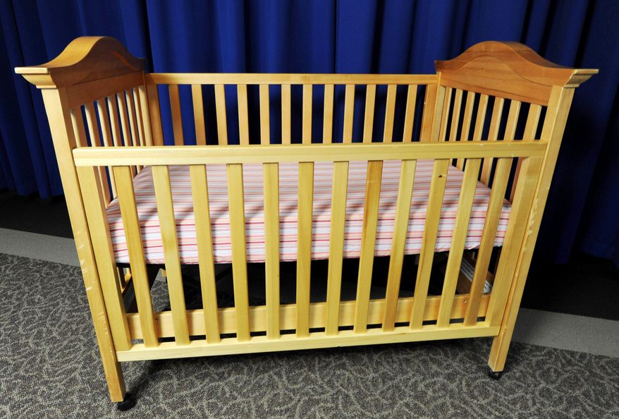 Drop-side cribs such as this one are set to become a thing of the past beginning Tuesday, when federal rules take effect banning their manufacture, sale or resale. (Associated Press)